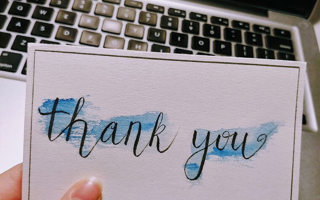 picture of a thank you card with watercolour splashing in the background