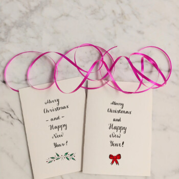 Tombow calligraphy pen. picture of two cards that say "merry christmas and happy new year" side by side