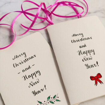 Tombow calligraphy pen. picture of two cards that say "merry christmas and happy new year" side by side