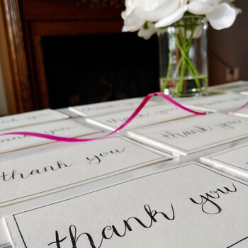 One of 30 cards done individually by hand for sponsors. zoomed in picture of a card that says "thank you" in a calligraphy font