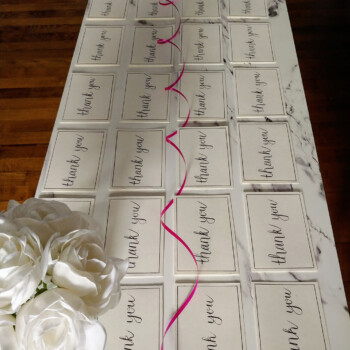 30 identical "thank you" cards done individually by hand for sponsors using Tombow calligraphy pen. picture of 24 cards that say "thank you" in a calligraphy font