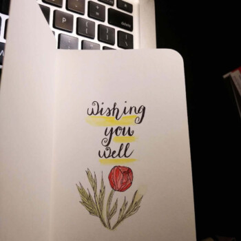 Tombow calligraphy pen, watercolour. picture of a card that says "wishing you well" with a flower