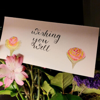 Tombow calligraphy pen, pencil crayons. A greeting card for grandparents. picture of a card that says "wishing you well" and two flowers