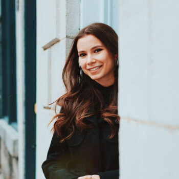 Photo by https://byabduls.com/work picture of a girl holding her hands together smiling into the camera